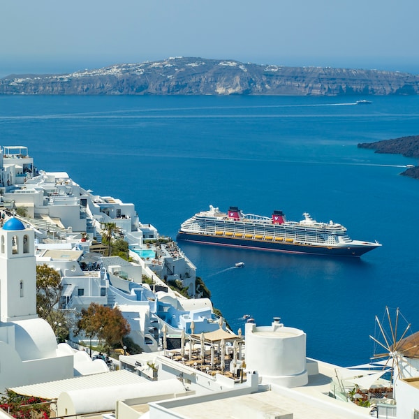 A Disney cruise ship entering the harbor of a Greek island