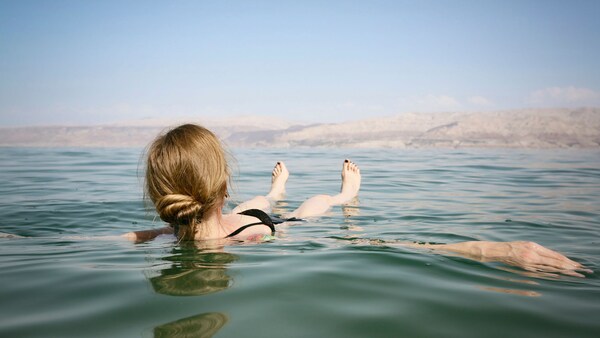 A woman floats on her back in the Dead Sea in Israel