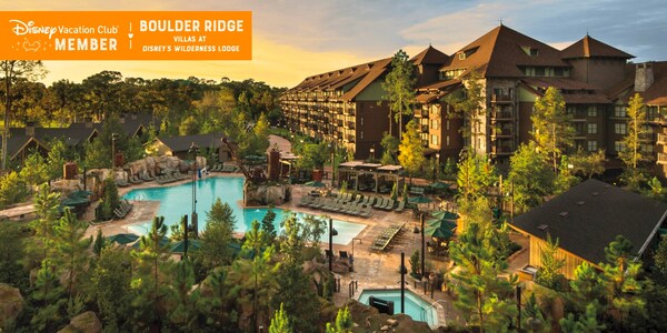 A large pool and the Boulder Ridge Villas, over which a banner reads, ‘Disney Vacation Club Member, Boulder Ridge Villas at Disney’s Wilderness Lodge’ 