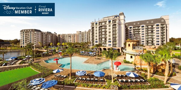 The magnificent Disney’s Riviera Resort and its large pool, over which a banner reads, ‘Disney Vacation Club Member, Disney’s Riviera Resort’