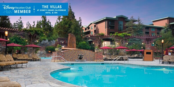 A pool, with Villas in the background, over which a banner reads, ‘Disney Vacation Club Member, The Villas at Disney’s Grand Californian Hotel and Spa’