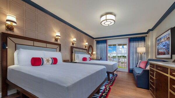 Una habitación con vista al lago de Disney's Yacht Club con 2 camas, un sofá, una cómoda y una terraza