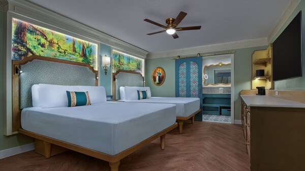 A hotel room with 2 queen beds and dresser at Disney's Port Orleans Resort Riverside