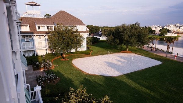 Bird's-eye view of a white sand volleyball court at a Disney Resort hotel