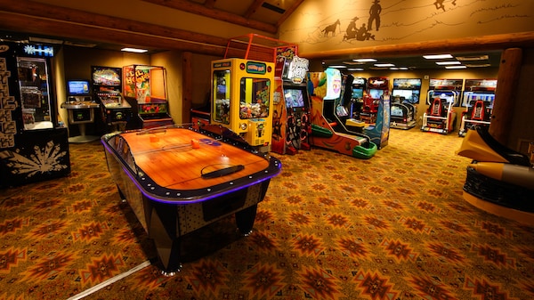 Large room with air hockey, basketball, racing and many other arcade games