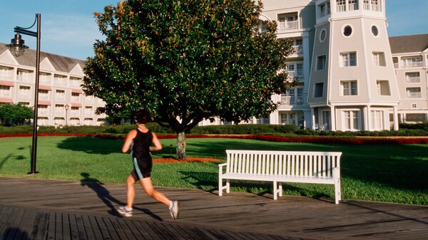 Close-up of a fishing pole with a bobber resting on a tree trunk