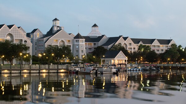 Lights glimmering off a body of water and the nearby boats parked outside the Ship Shape Health Club