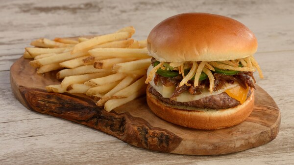 Showstopper Burger featuring a burger with cheese, jalapeños, crispy onions and fries on the side