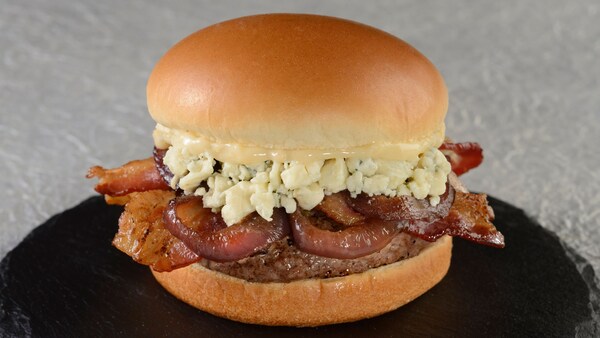 Blues Burger featuring a hamburger with bleu cheese, caramelized onions, bacon and garlic aioli 