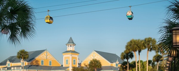 Disney’s Caribbean Beach Resort, featuring a tower with a spire and the Skyliner, a gondola lift that runs above the buildings