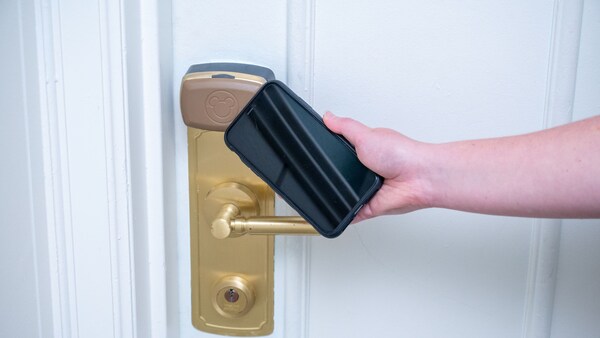 A phone being used to open an electronic room lock at Disney’s Yacht Club Resort