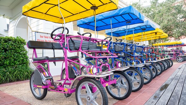 A row of rental Surrey Bikes at Disney’s BoardWalk Inn