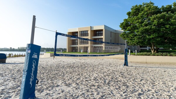 A beach volleyball court set up near a lake at Disney's Contemporary Resort