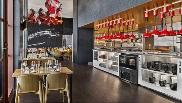 Dining tables and an open kitchen at Capa, a steakhouse at the Four Seasons Hotel Orlando  at Walt Disney World Resort