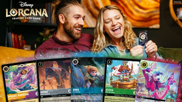 Two people playing the Disney Lorcana Trading Card Game with an array of 5 trading cards spread out