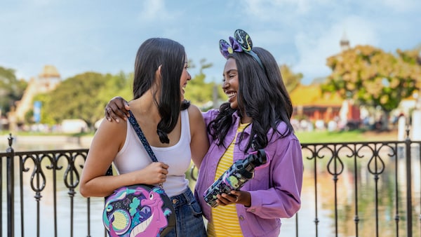 2 young women at EPCOT wearing accessories from the 2026 EPCOT International Festival of the Arts Collection