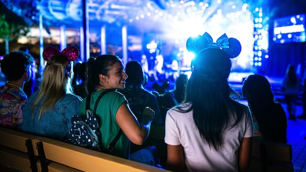Guests enjoying a nighttime musical show from the Eat to the Beat Concert Series at Epcot
