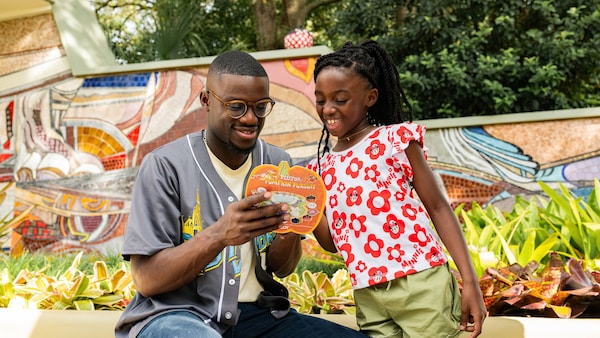 A father and daughter participating in Pluto’s Pumpkin Pursuit at Epcot International Food & Wine Festival