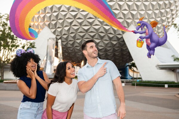 Three Guests posing in front of Spaceship Earth with a Magic Shot overlay featuring Figment