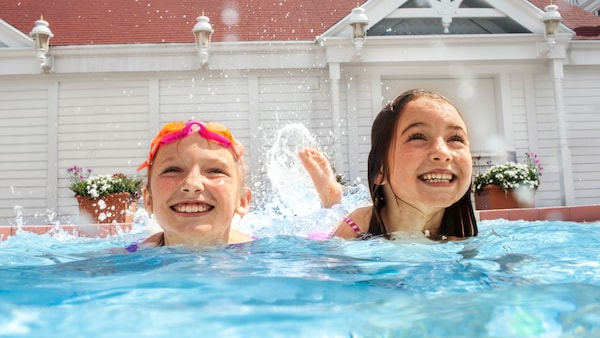 Two young girls frolic in a pool at Disney’s Grand Floridian Resort & Spa