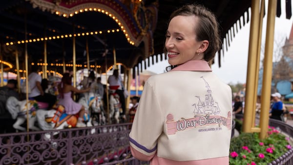 A Guest in a Walt Disney World Resort jacket looking over her shoulder