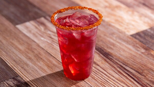 A Hibiscus Mezcal Margarita served in a glass with a salted rim