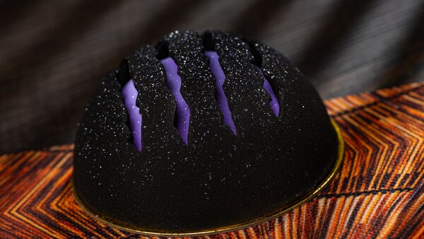 A round chocolate mousse cake with Black Panther claw scratches across the top