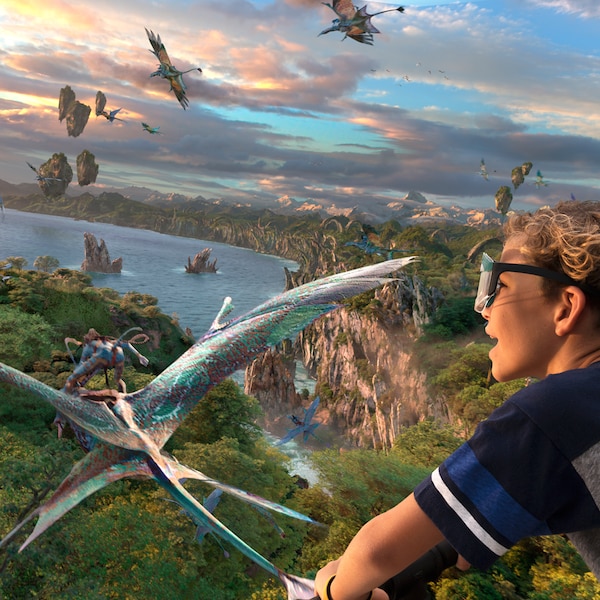 A boy flies through the sky with Na'vi and Mountain Banshees through the skies over Pandora
