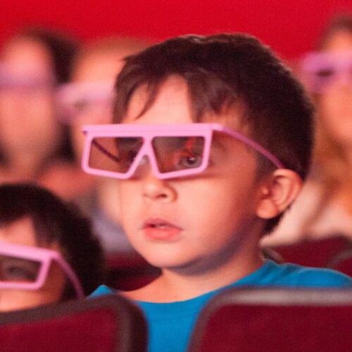Two young boys wearing 3 D glasses in a theater at the Disney and Pixar Short Film Festival