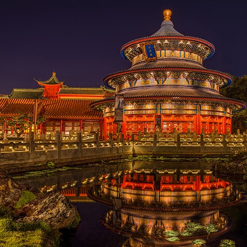 Nighttime view of the Temple of Heaven and its reflection in a pond at the China Pavilion at Epcot