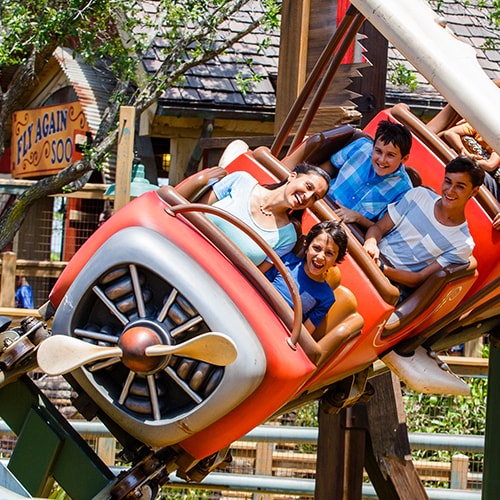 Guests delight in riding The Barnstormer rollercoaster attraction in Fantasyland