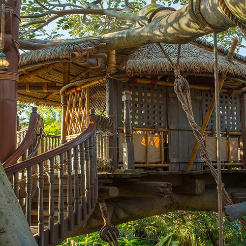 A spiral staircase leading to a room on a platform at Swiss Family Treehouse
