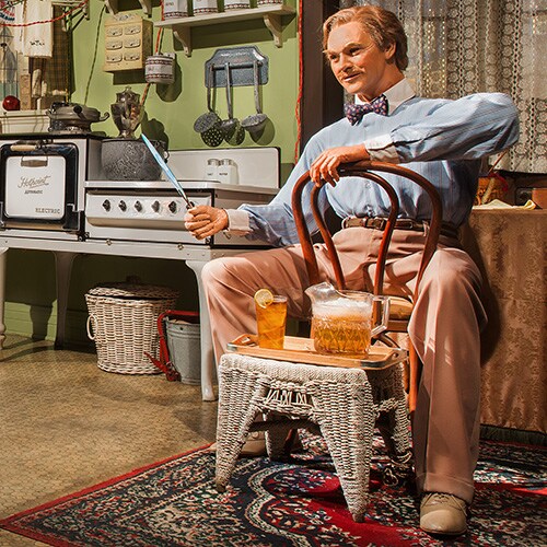 An Audio-Animatronic man sits in a house with the latest conveniences of the 1920s