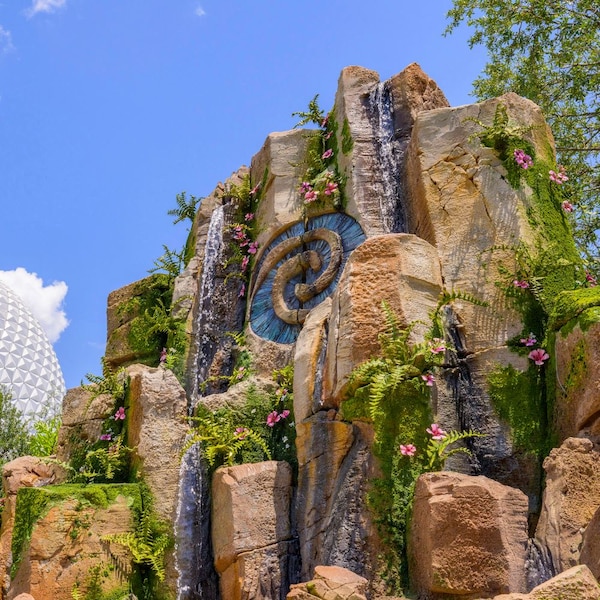 A small waterfall over a rock formation that features the Heart of Te Fiti symbol on the Journey of Water, Inspired by Moana trail