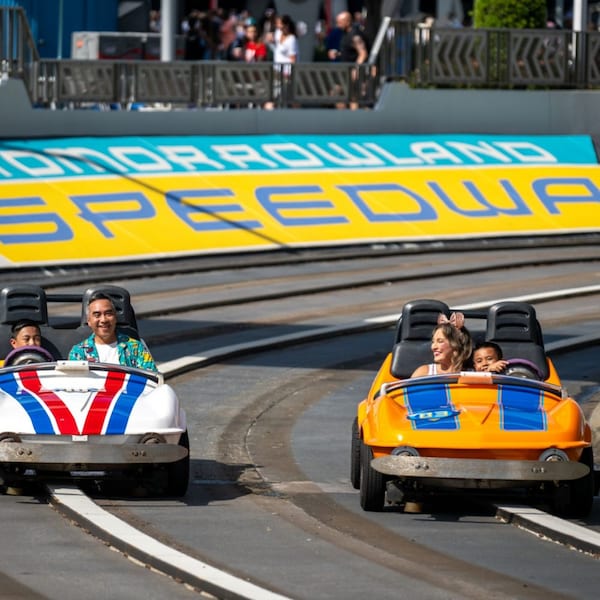 Guests cruising along Tomorrowland Speedway in Magic Kingdom park