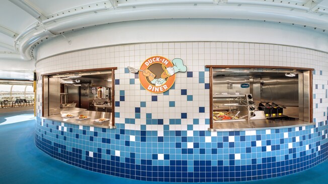 Two service windows flank a Duck In Diner sign featuring Donald Duck with a spatula