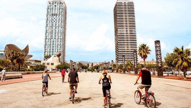 A group of cyclists riding on a bike path in Barcelona, Spain