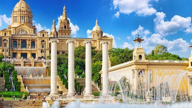 A splashing fountain stands in front of the monumental National Art Museum of Catalunya. A splashing fountain stands in front of the monumental National Art Museum of Catalunya.