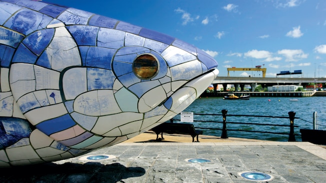 A ceramic mosaic sculpture of a big fish situated next to a waterfront A ceramic mosaic sculpture of a big fish situated next to a waterfront
