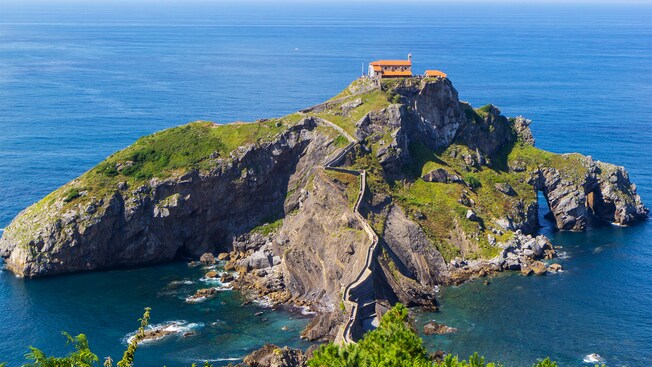 A staircase leading to the top of a rocky islet with a church