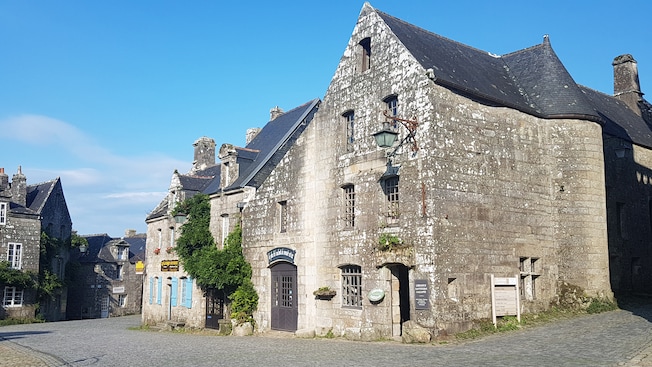 A French village featuring cobblestone streets and late medieval architecture A French village featuring cobblestone streets and late medieval architecture
