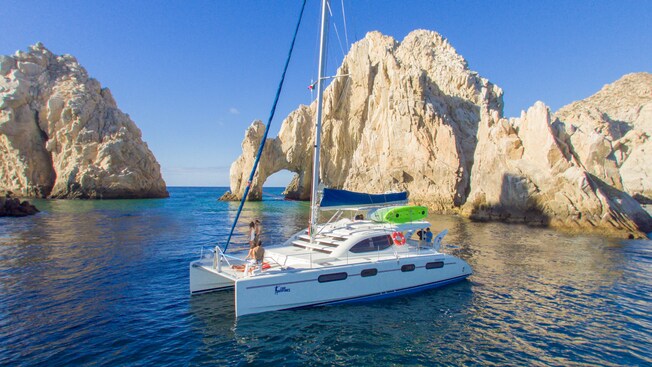A catamaran docked close to El Arco land formation in Los Cabos, Mexico