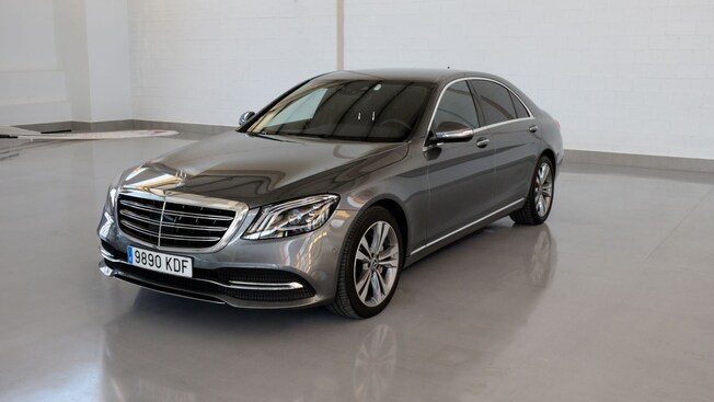 A shiny luxury sedan, parked indoor