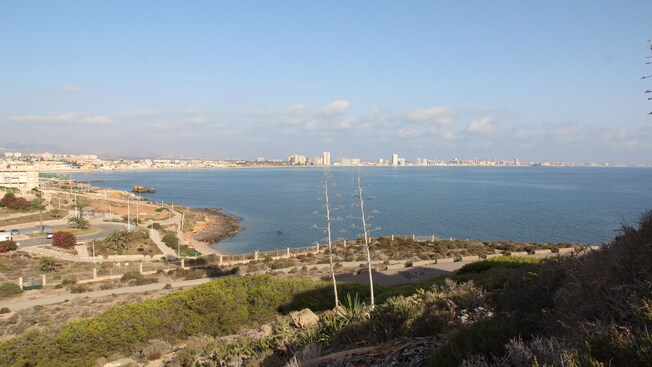A placid seascape against a developed landscape
