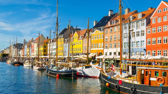 A waterfront lined with sailboats and historic buildings
