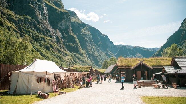 A recreation of a medieval village situated next to a fjord