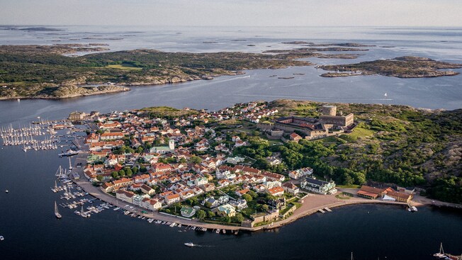 The Isle of Marstrand from above reveals sailboats in the harbor, wooden cottages and a stone fortress on a hill