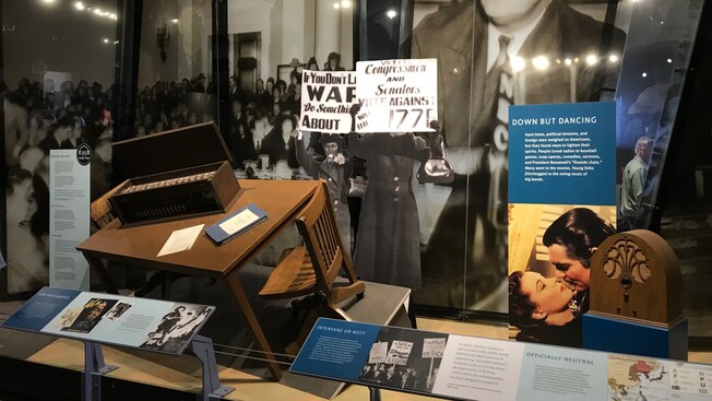 An exhibit featuring World War 2 era articles, artifacts and photographs