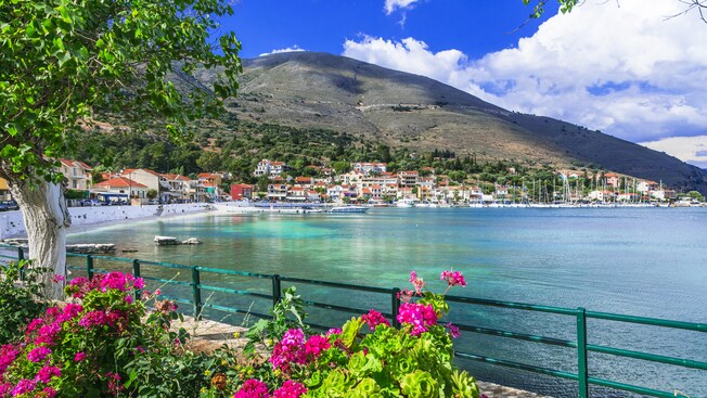 A port village with boats in the water and shops and restaurants on land