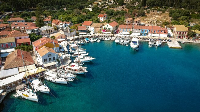 A stunning port village with boats in the water and colorful homes